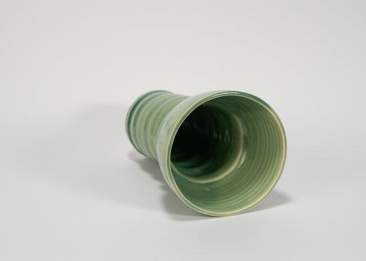 Green ceramic vase on a white background