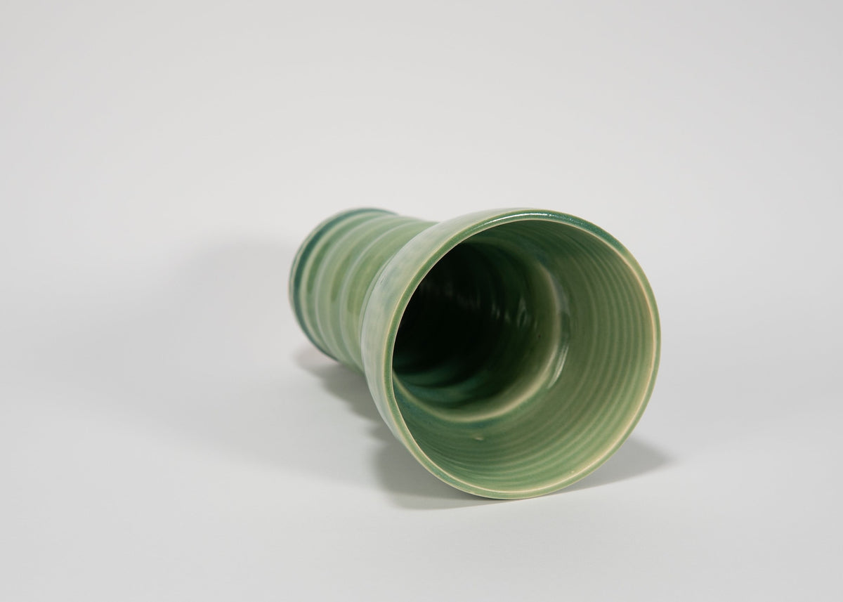 Green ceramic vase on a white background
